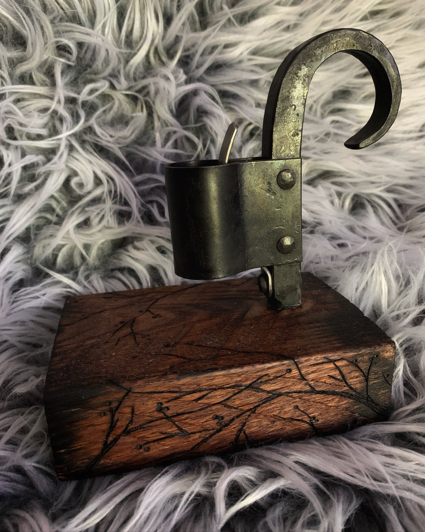 Decorative candle holder on a wooden base with a textured white background